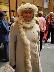 Mary Janis models her handwoven coat & hat in the atrium, following the Fashion Show